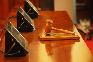Stock photo showing a gavel and monitors to represent a war crimes tribunal.